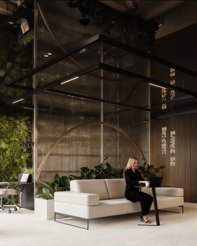 Lounge in a building's common area with greenery and designer lighting